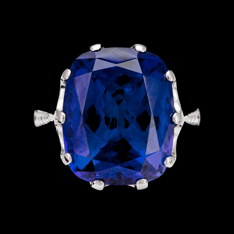 A large tanzanite, 24.34 cts, and brilliant cut diamond ring, tot. app. 1.0 cts.