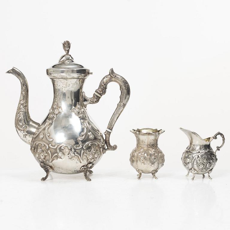 A silver Rococo style coffee pot, creamer and sugar bowl, Swedish import mark of Gewe Silvervarufabriken Ab, Malmö, 1977.