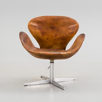 An Arne Jacobsen steel and brown leather 'Swan' chair, Fritz Hansen, Denmark 1960's.