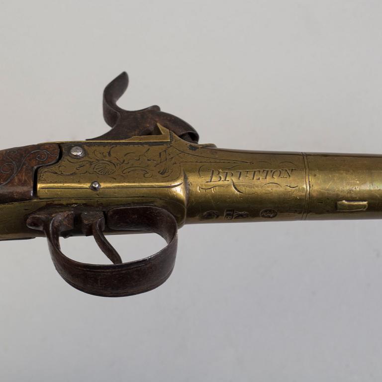 A secon half of the 19th century pair of Queen Anne brass percussion pistols converted from flintlock by Brueton, London.