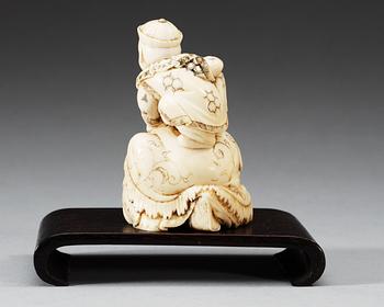 A carved ivory figure of two boys playing with at turtle, Qing dynasty.