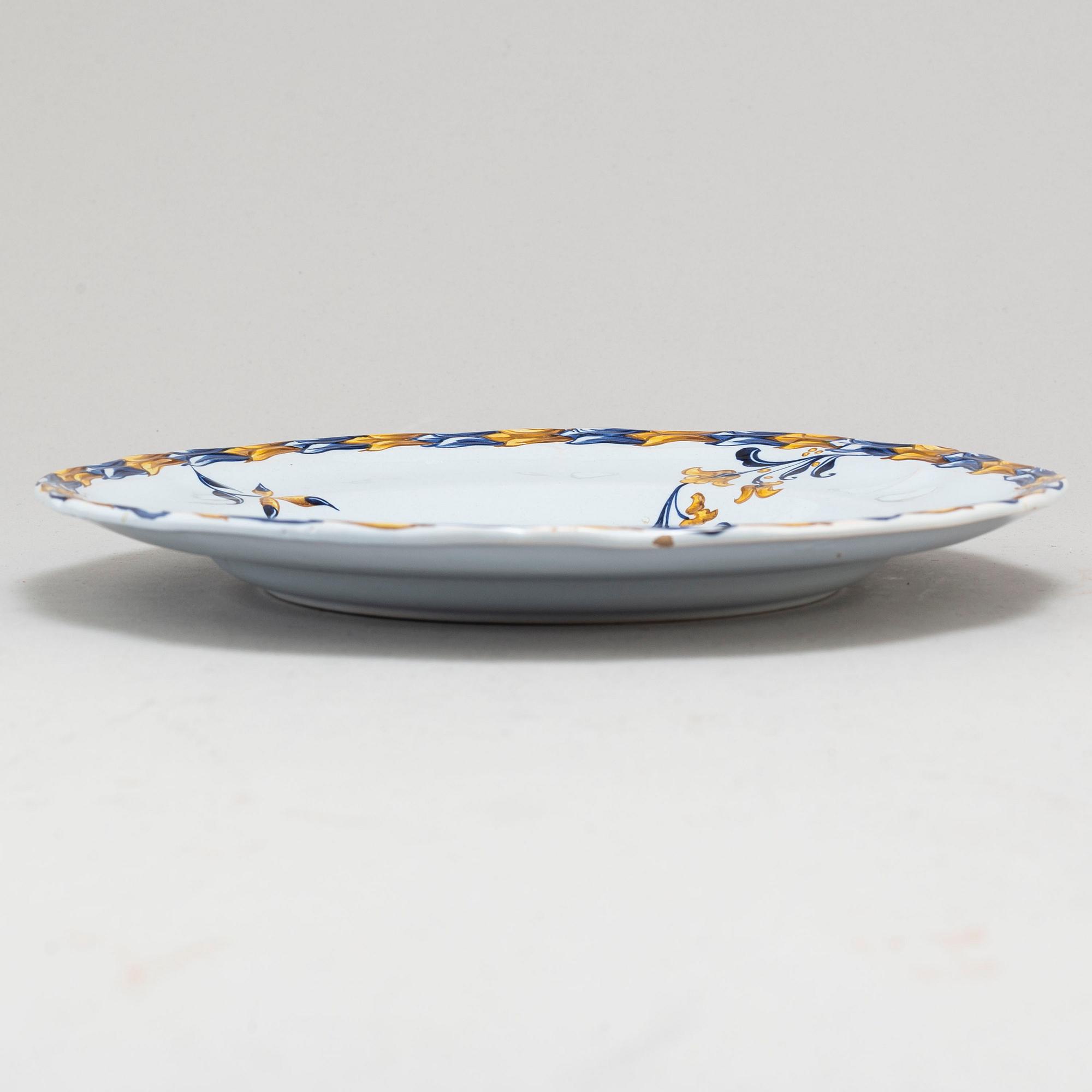 A set of four french faience cabinet plates signed Emile Gallé, Nancy. C. 1900.