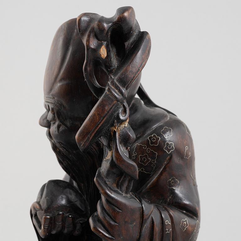 A Chinese wooden figure of 'Shoulao' with silver inlays, 20th century.