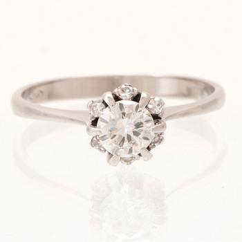 An 18K white gold ring set with a round brilliant cut diamond and single cut diamonds.