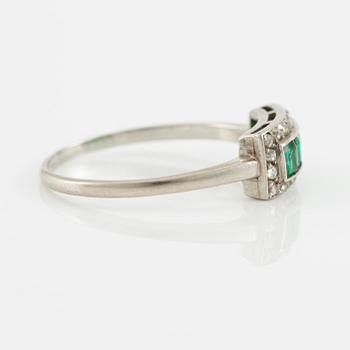 Ring in platinum set with step-cut emeralds and rose-cut diamonds.