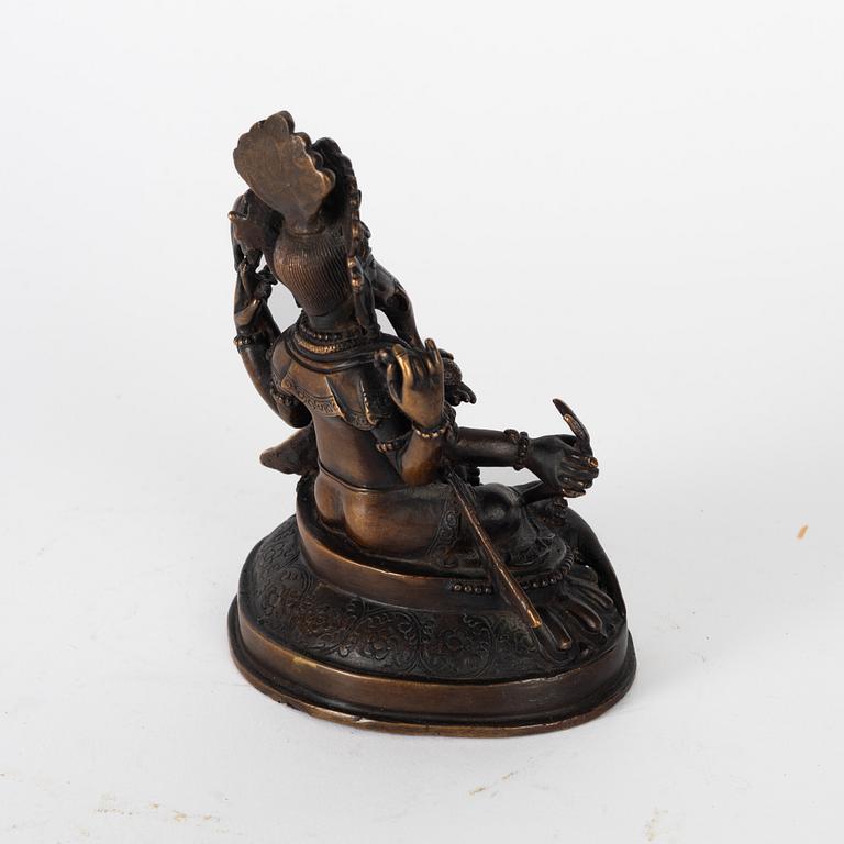 A Nepalese bronze deity, 20th century.