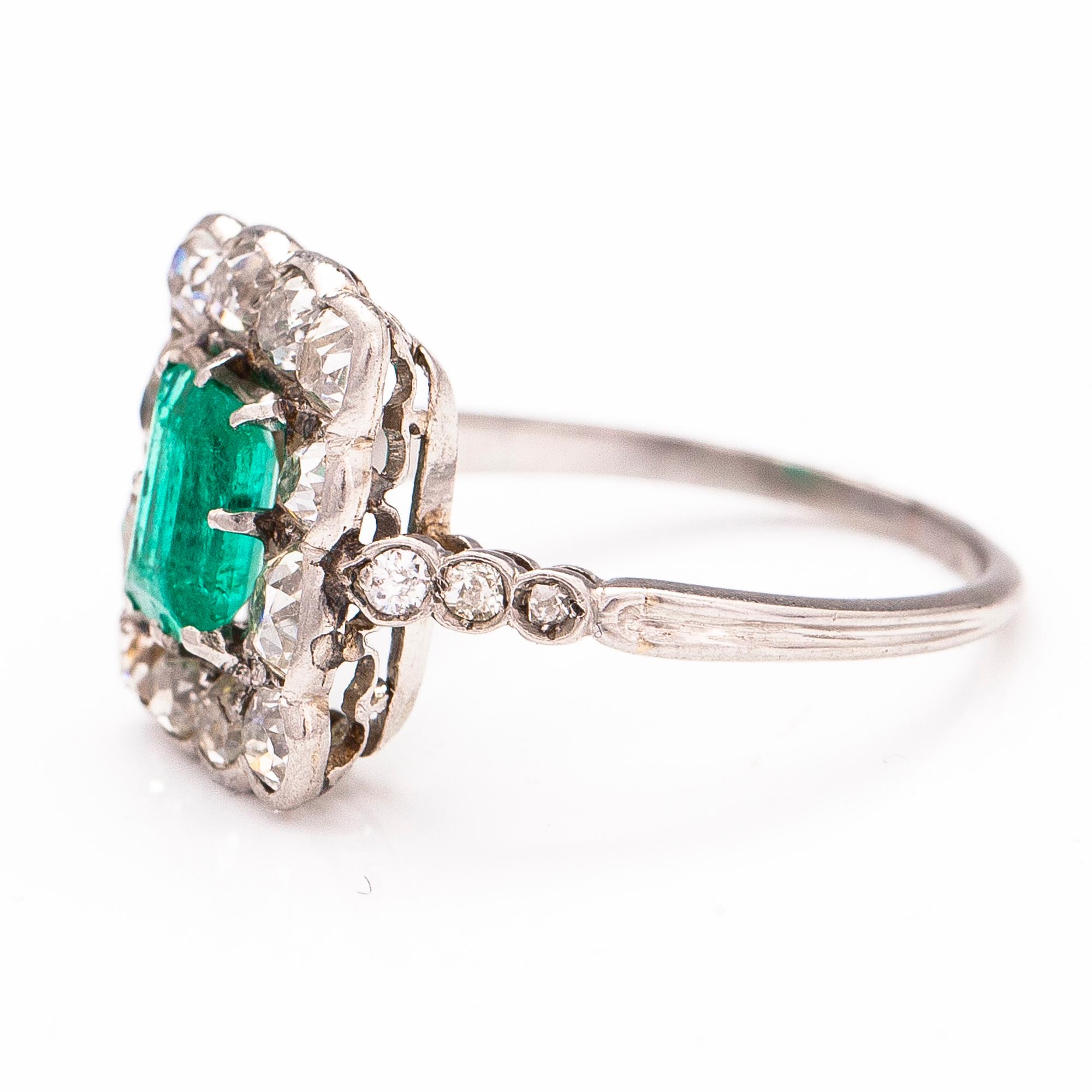 A platinum ring with an emerald ca 0.71 ct and old cut diamonds ca 1.66 ct in total.