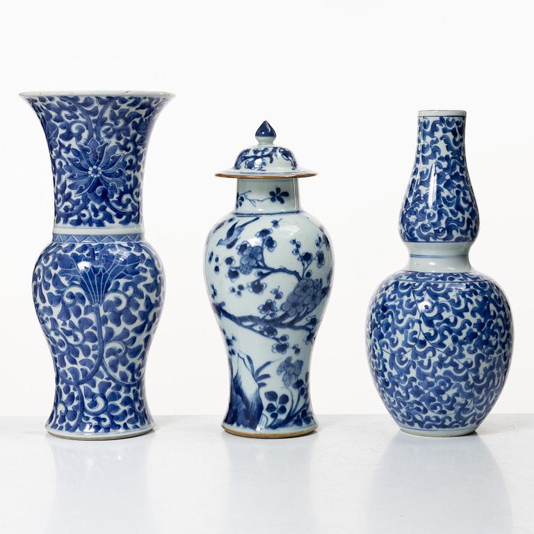 Two blue and white vases, Qing dynasty, 19th century and a blue and white vase with cover, 18th century.
