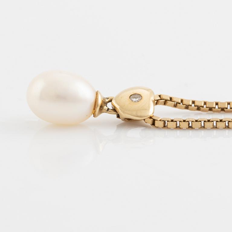 Cultured pearl and heart with small brilliant cut diamond necklace.