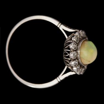 An opal, 1.25 cts and diamond ring.