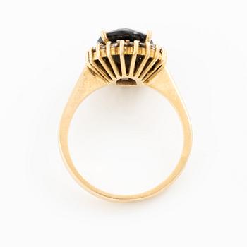 Ring, 18K gold with dark sapphire and brilliant-cut diamonds.