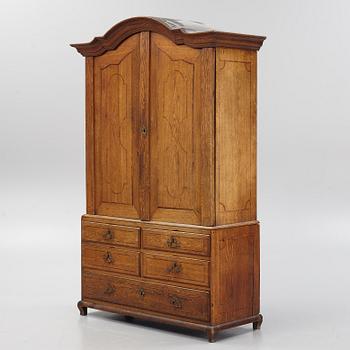 An oak rococo cabinet, mid 18th Century.