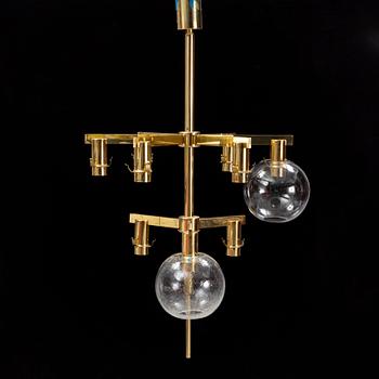 A brass chandelier with two glass globes by Hans-Agne Jacobsson, Markaryd.