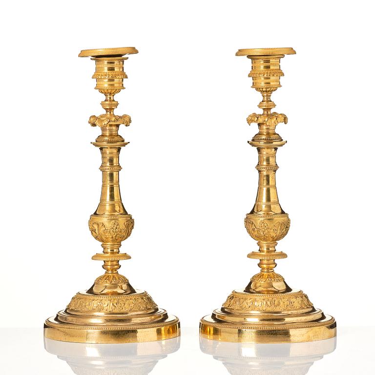 A pair of French Empire candlesticks.
