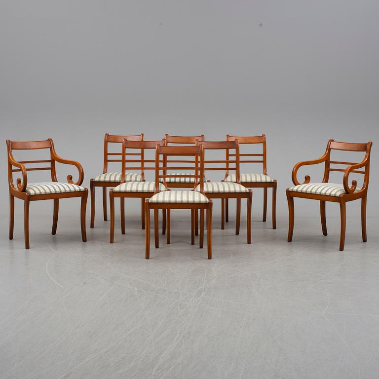 a late 20th century dining table with eight chairs.