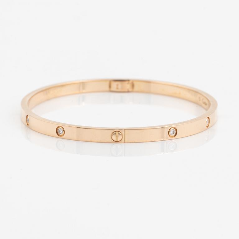 A Cartier "Love" bracelet small model in 18K rose gold with ten round brilliant-cut diamonds.