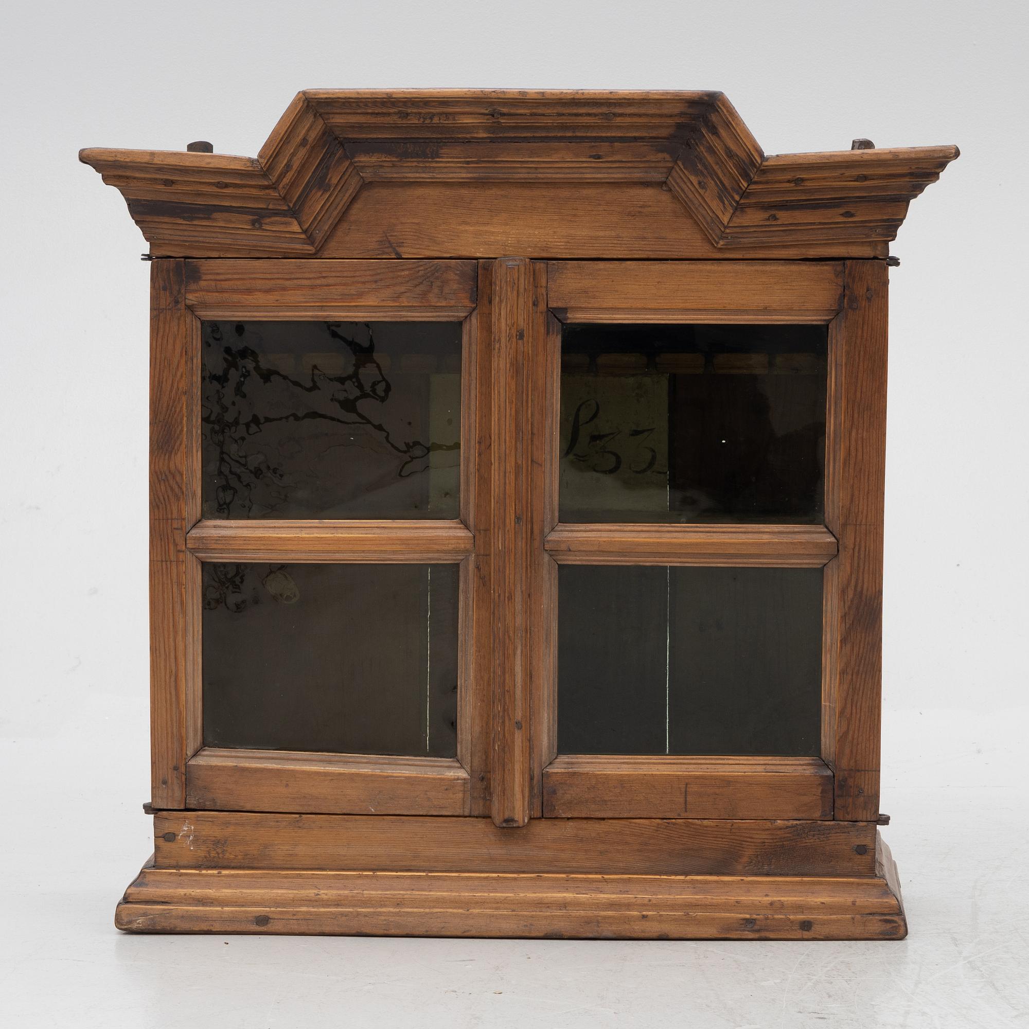 A 18th century wall vitrine cabinet.