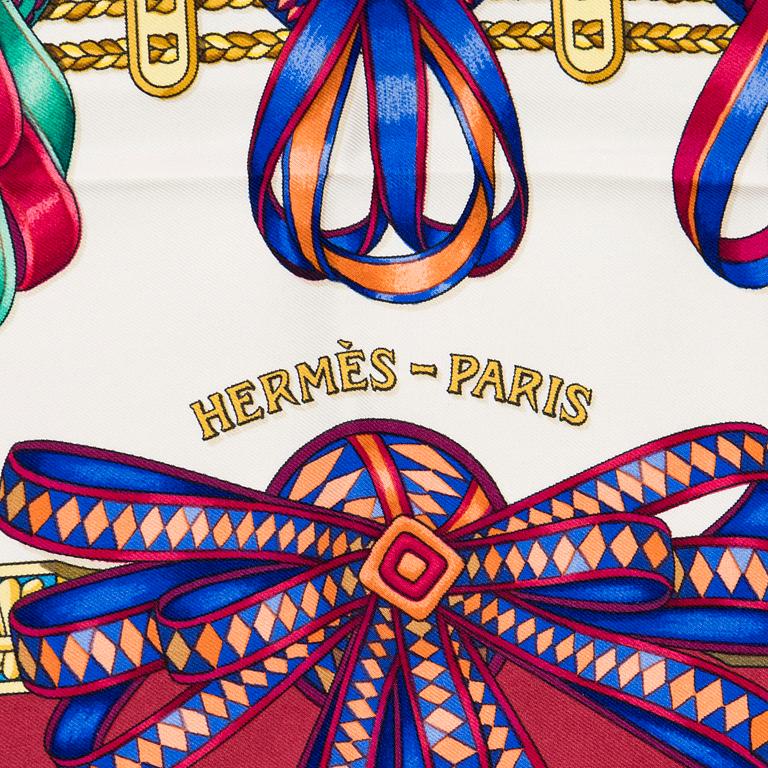 Hermès, a 'Les Rubans du Cheval' silk scarf.