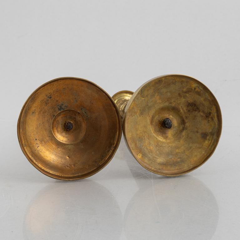 A pair of Empire gilt brass candle sticks, first half of the 20th century.