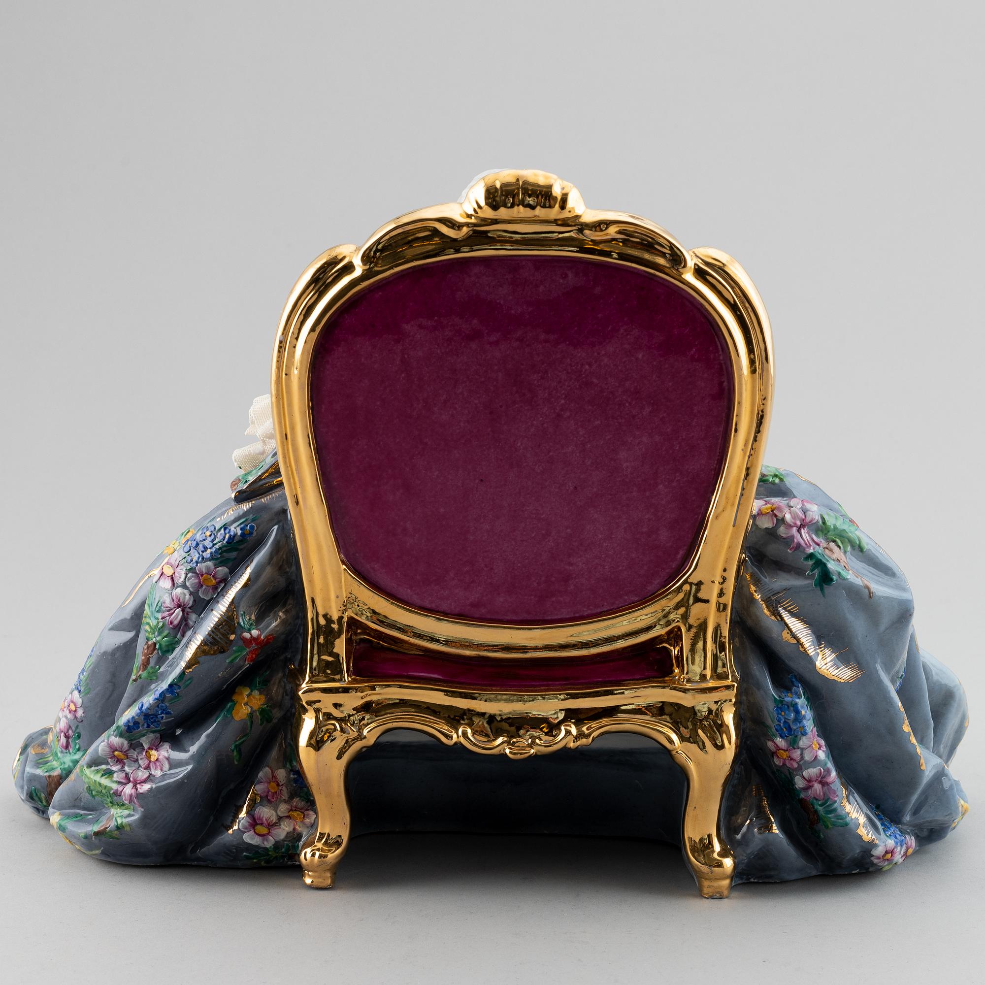 A porcelain figurine of a seated Rococo lady, 20th century, Italy.
