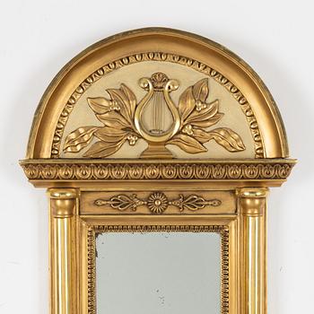 An Empire mirror, first half of the 19th century.