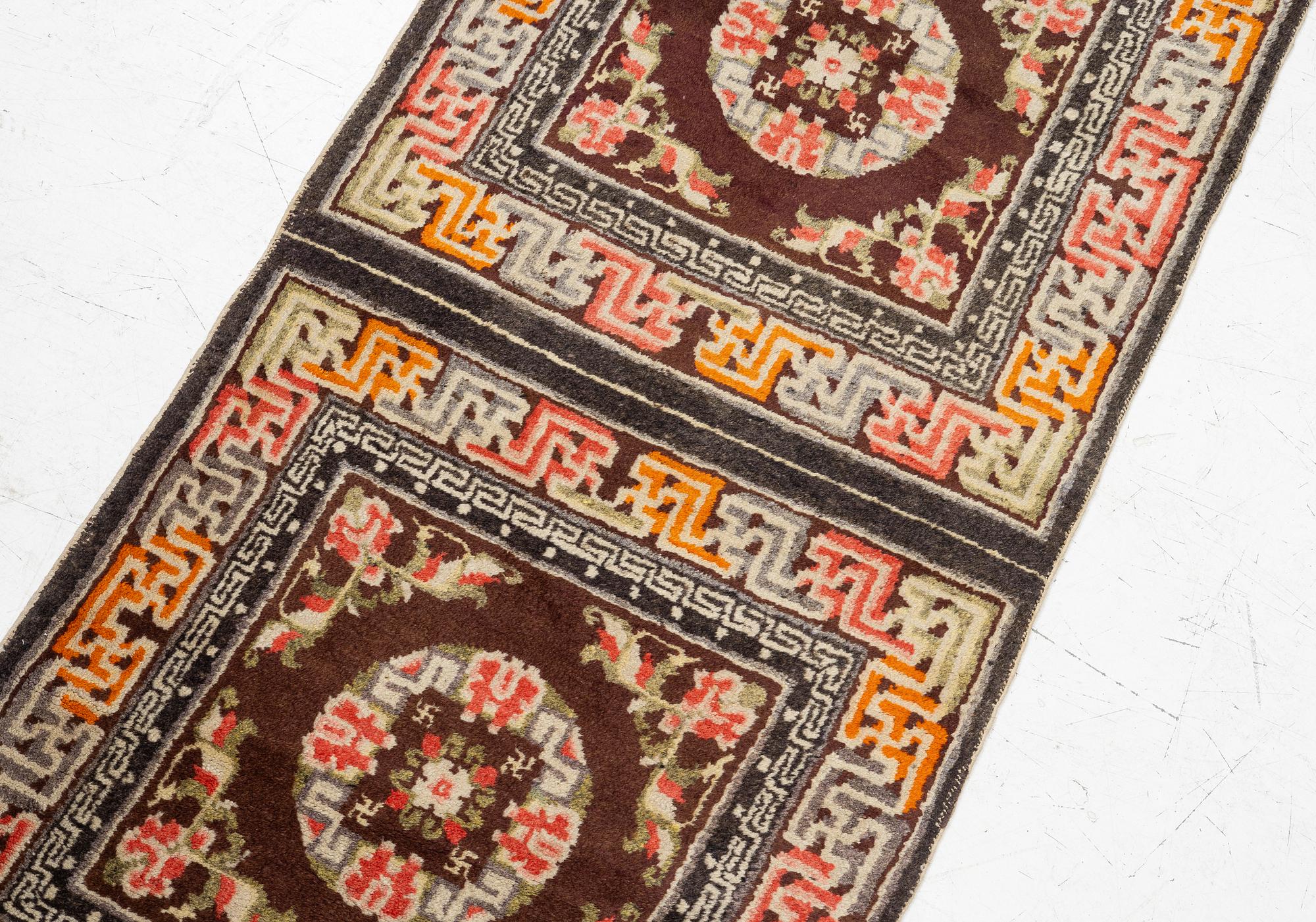 A Chinese two square rug, antique, c. 142 x 71 cm.