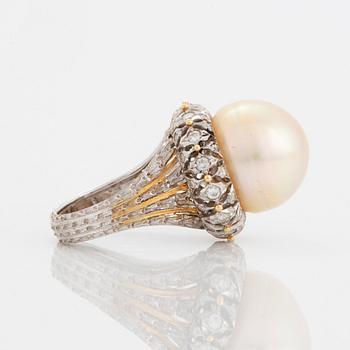 An 18K gold ring set with a cultured pearl and round brilliant-cut diamonds.