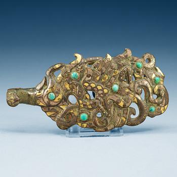 An archaistic silver and gilt bronze garment hook.