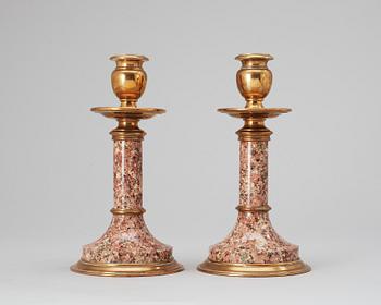 757. A pair of Swedish 19th cent granite-like and brass candlesticks.