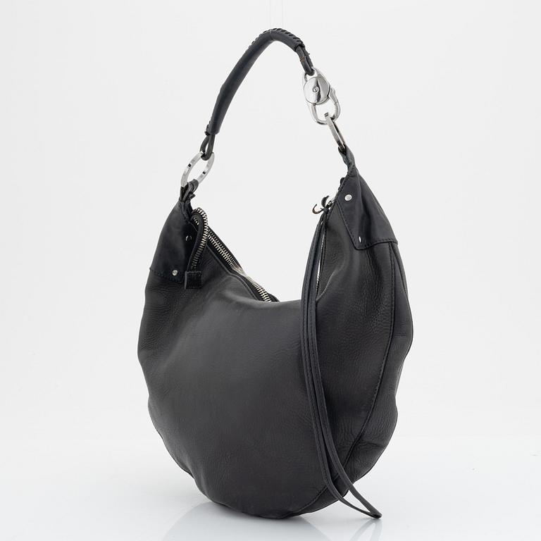 Gucci, a leather bag.