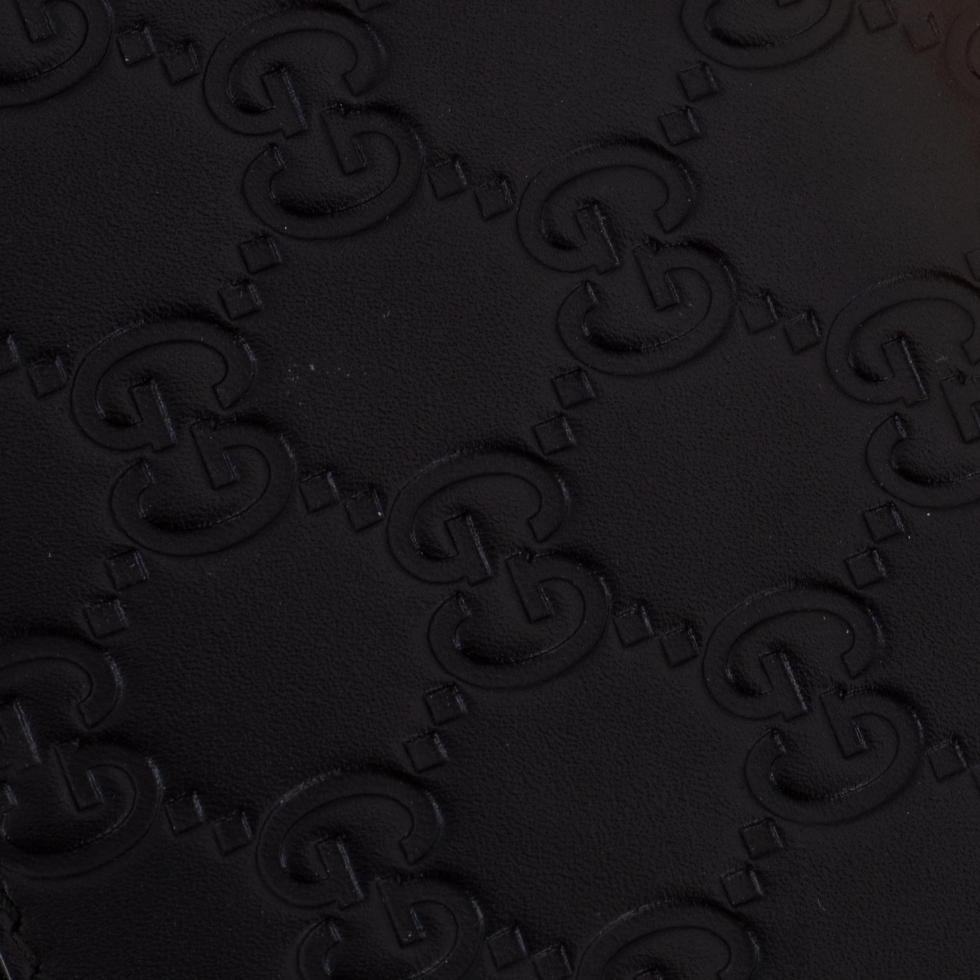 Gucci, an embossed böack leather wallet.