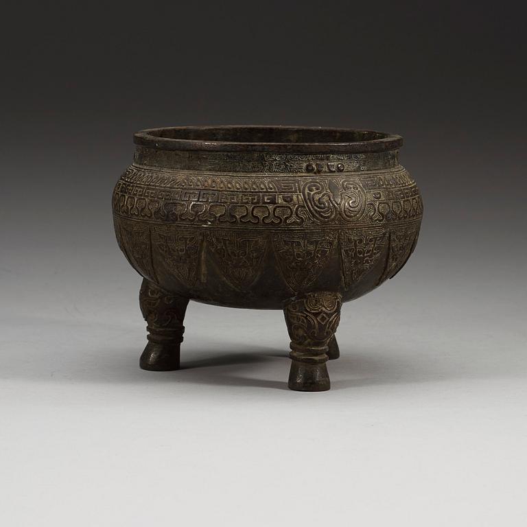 A bronze tripod censer, presumably Ming dynasty.