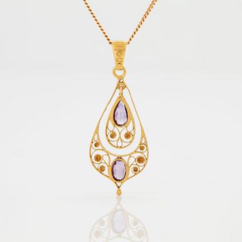 A PENDANT set with amethysts.