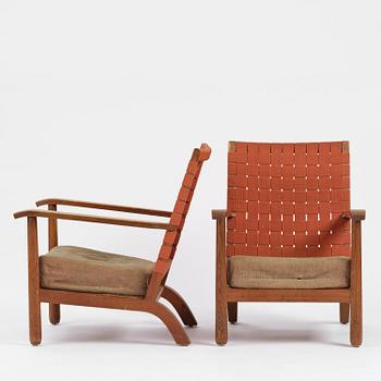 Axel Einar Hjorth, a pair of stained pine "Väddö" easy chairs, Nordiska Kompaniet, Sweden, 1930s-40s.