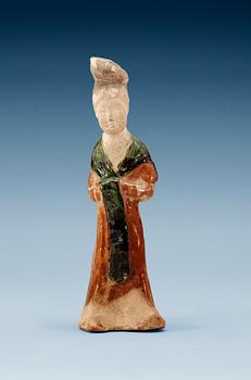 1623. A green and yellow glazed figure of a standing lady, Tang dynasty.