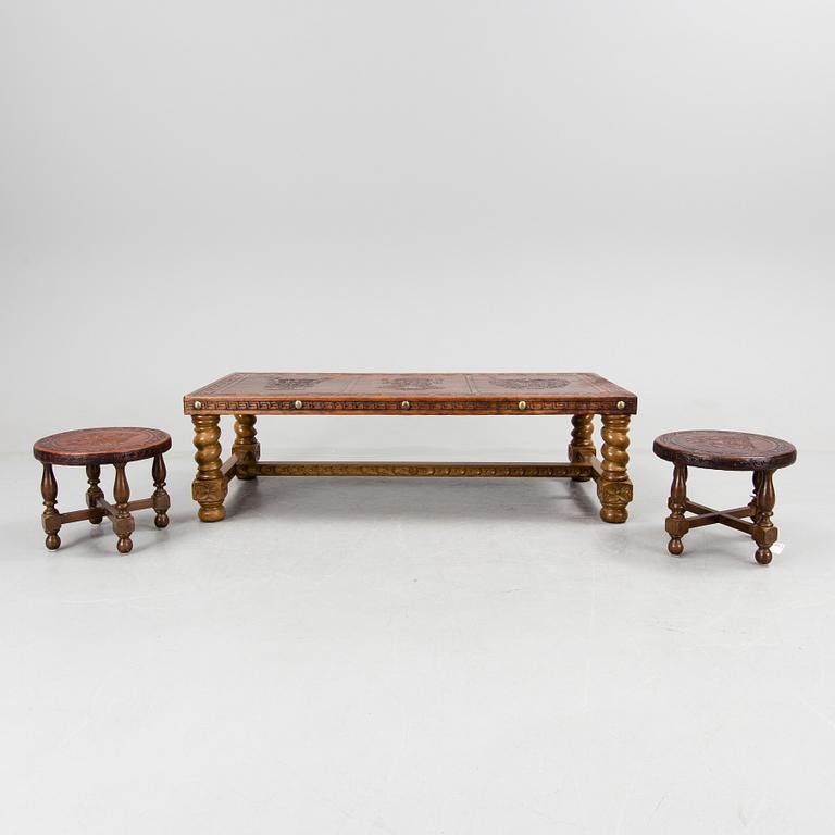 A Peruvian leather covered coffee table and pair of stools, second half of the 20th Century.