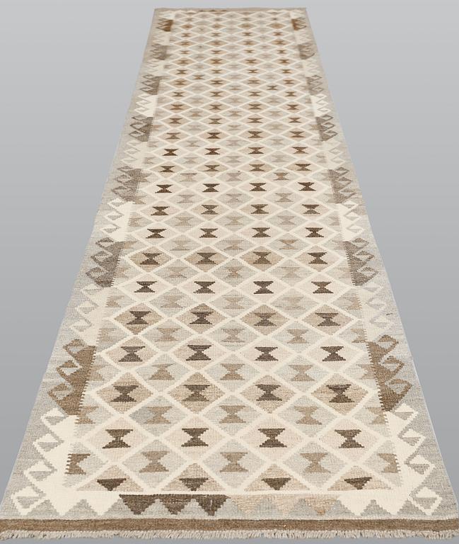 A Kilim runner, c. 394 x 82 cm.