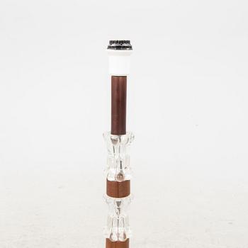 A 1970s wood and glass floor lamp.