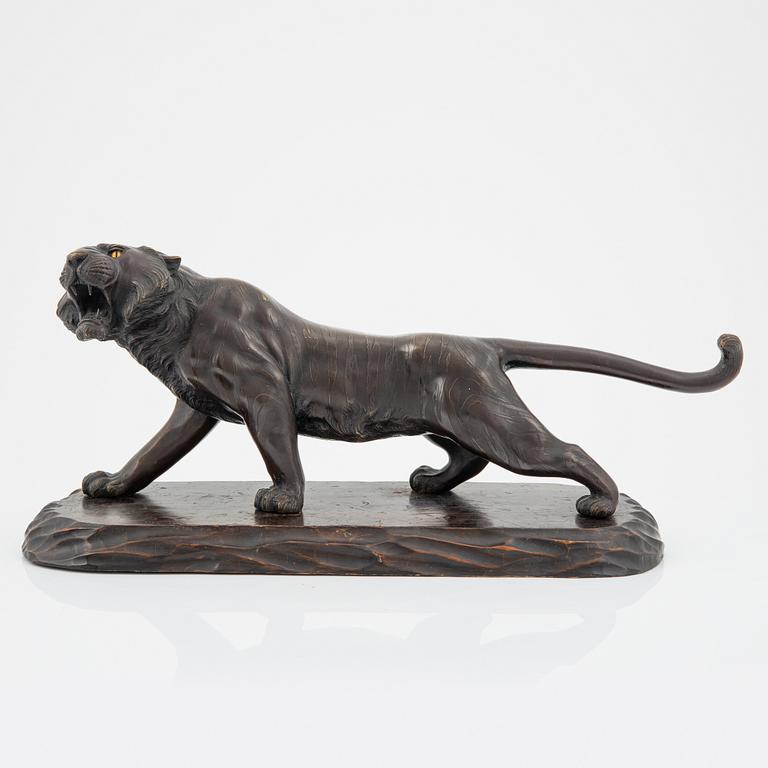 A Japanese sculpture of a tiger, 20th Century.