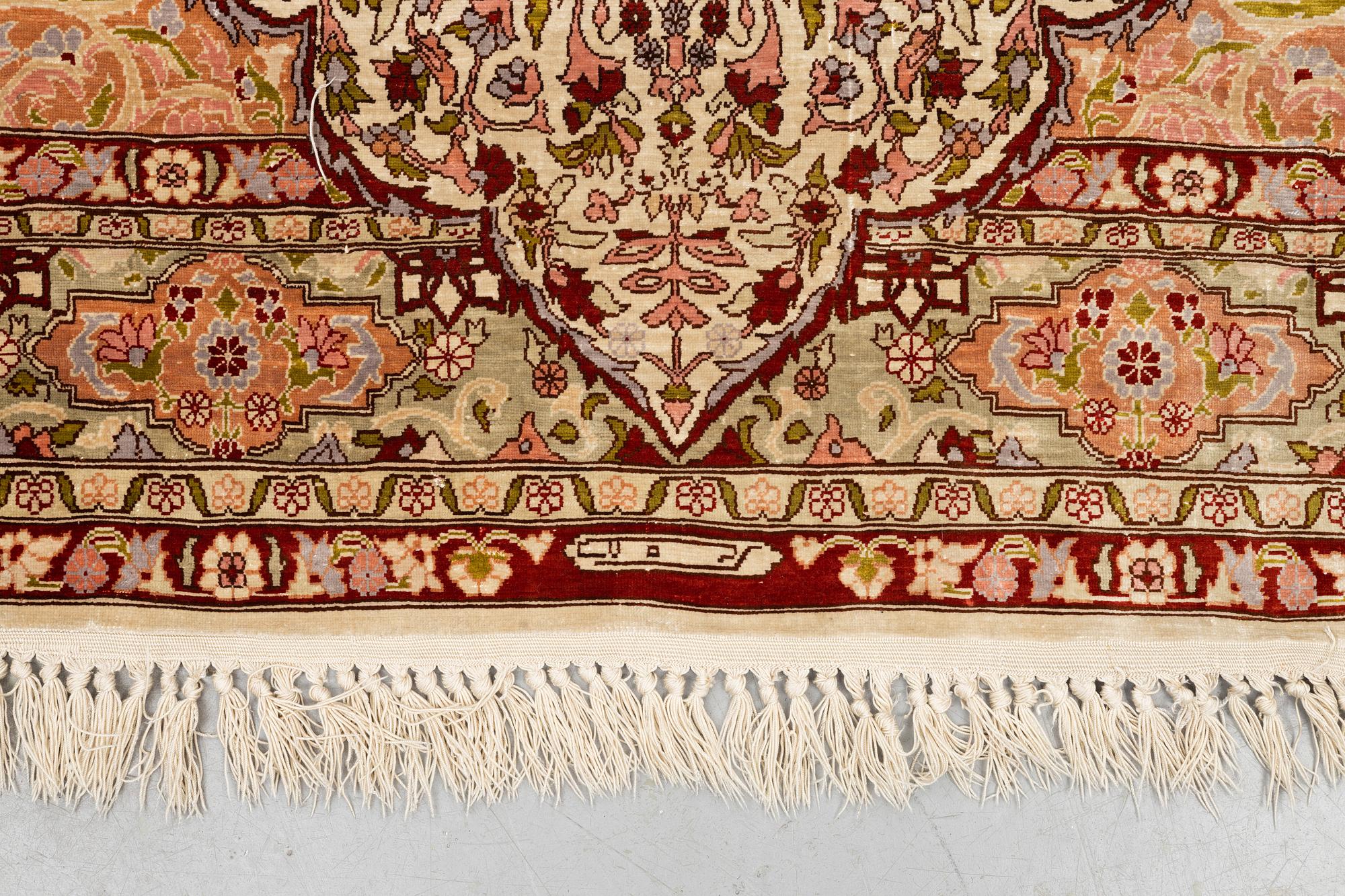 A rug, Old silk Hereke, ca 152 x 110 cm.