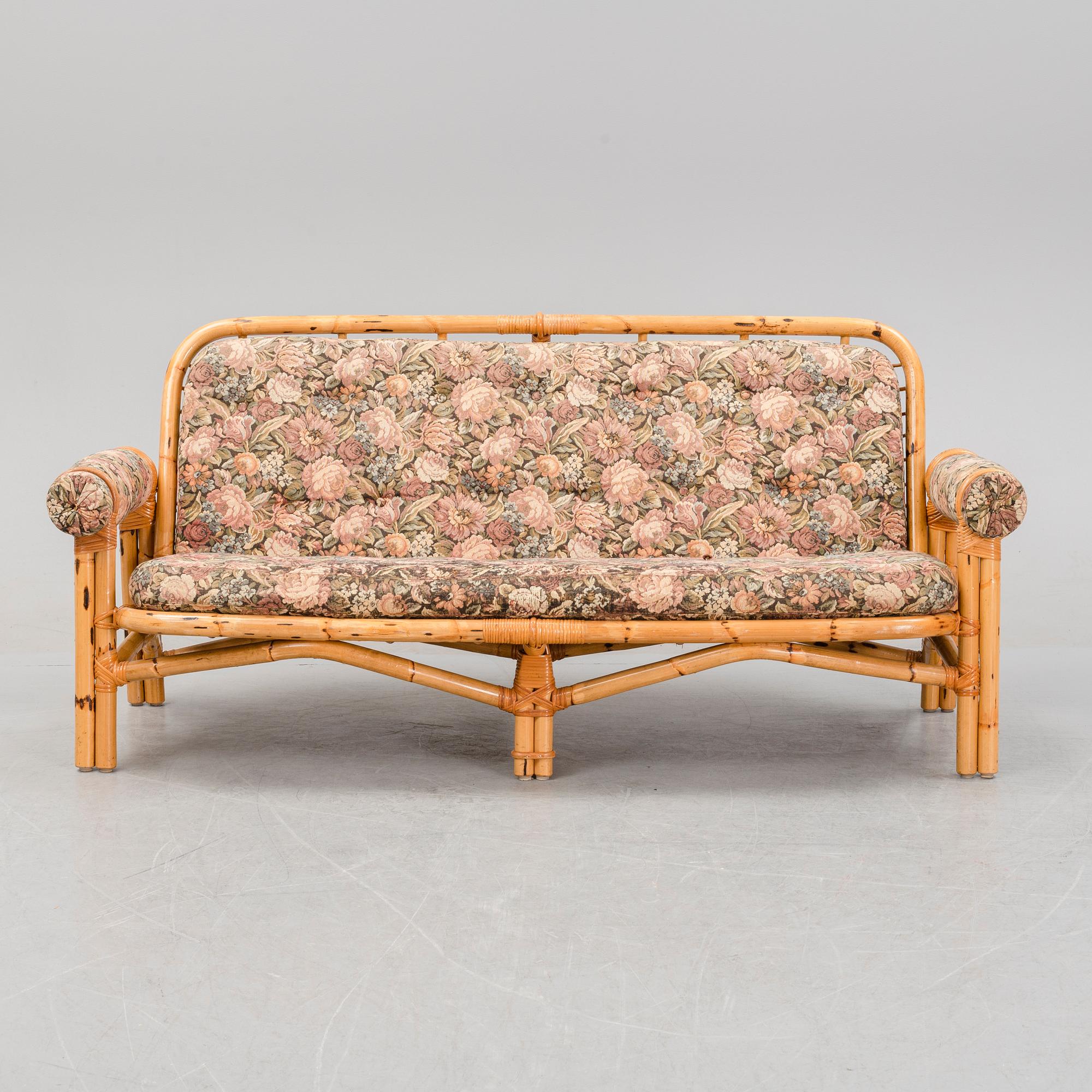 A set of two garden sofas, an armchair and a glass table, later part of the 20th Century.