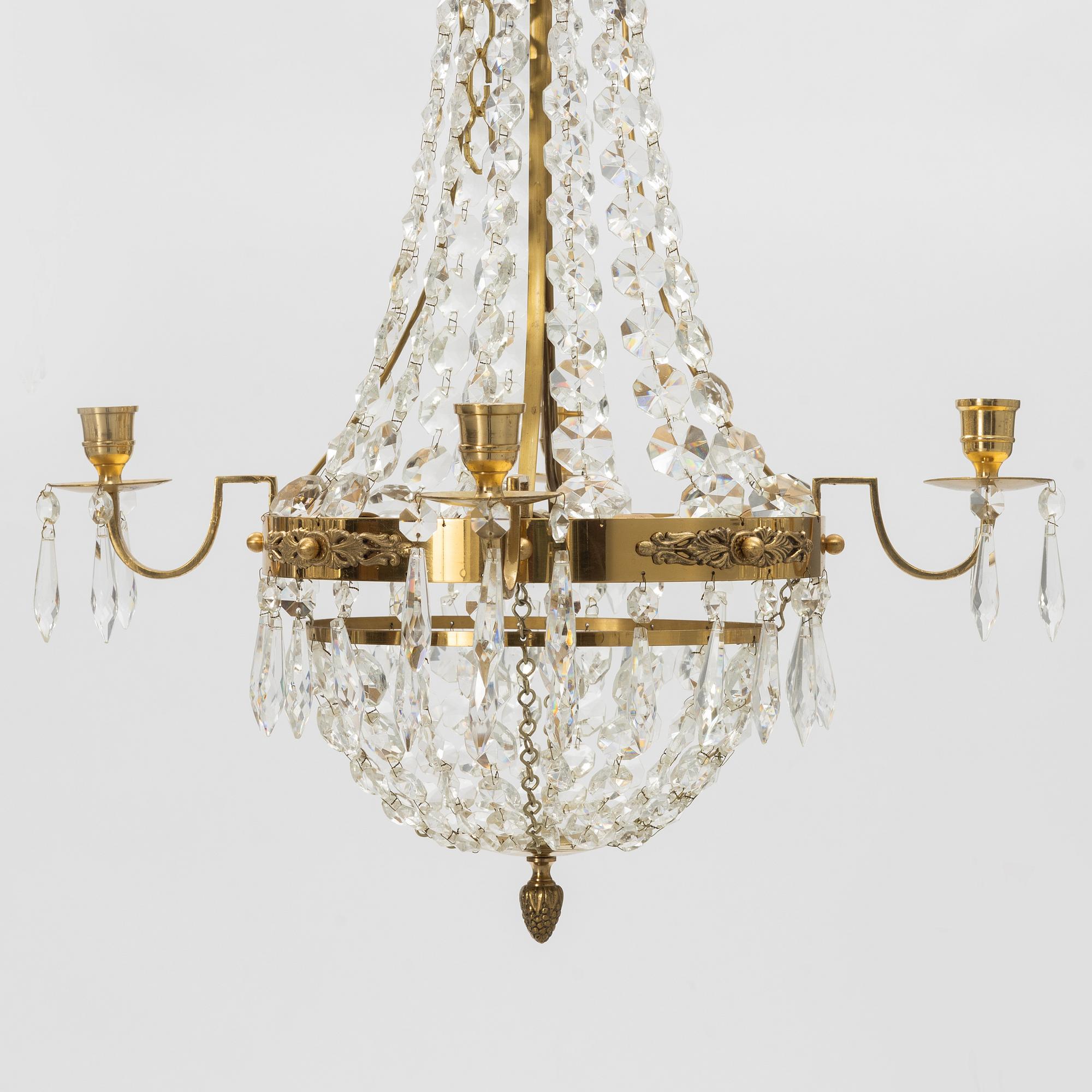 A contemporary matched pair of chandeliers for four candles each.