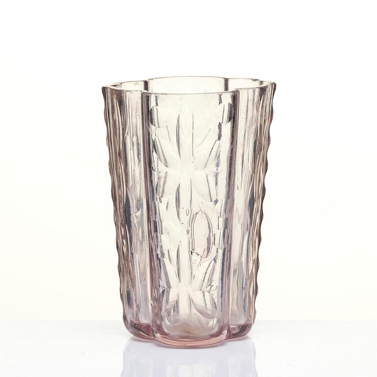 An amethyst coloured suger shaker and a cut glass goblet, 18th century.