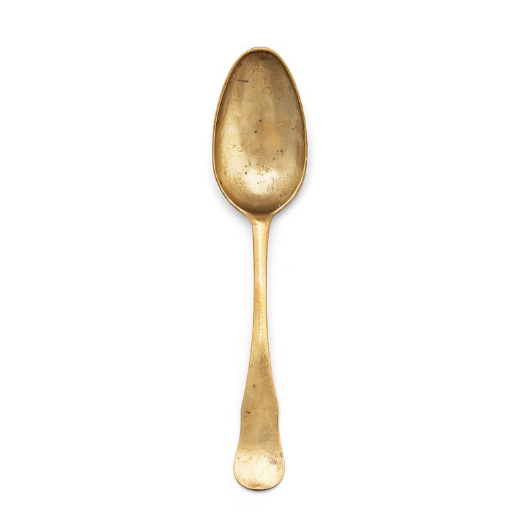 A brass (originally silver plated) spoon by Erik Castman.