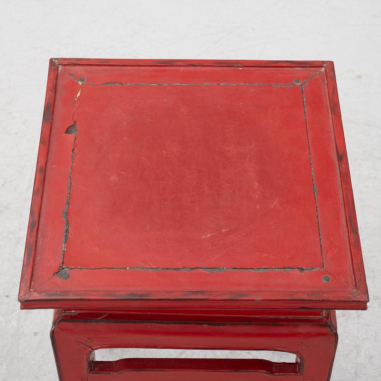 A pair of red Chinese small tables, 20th century.