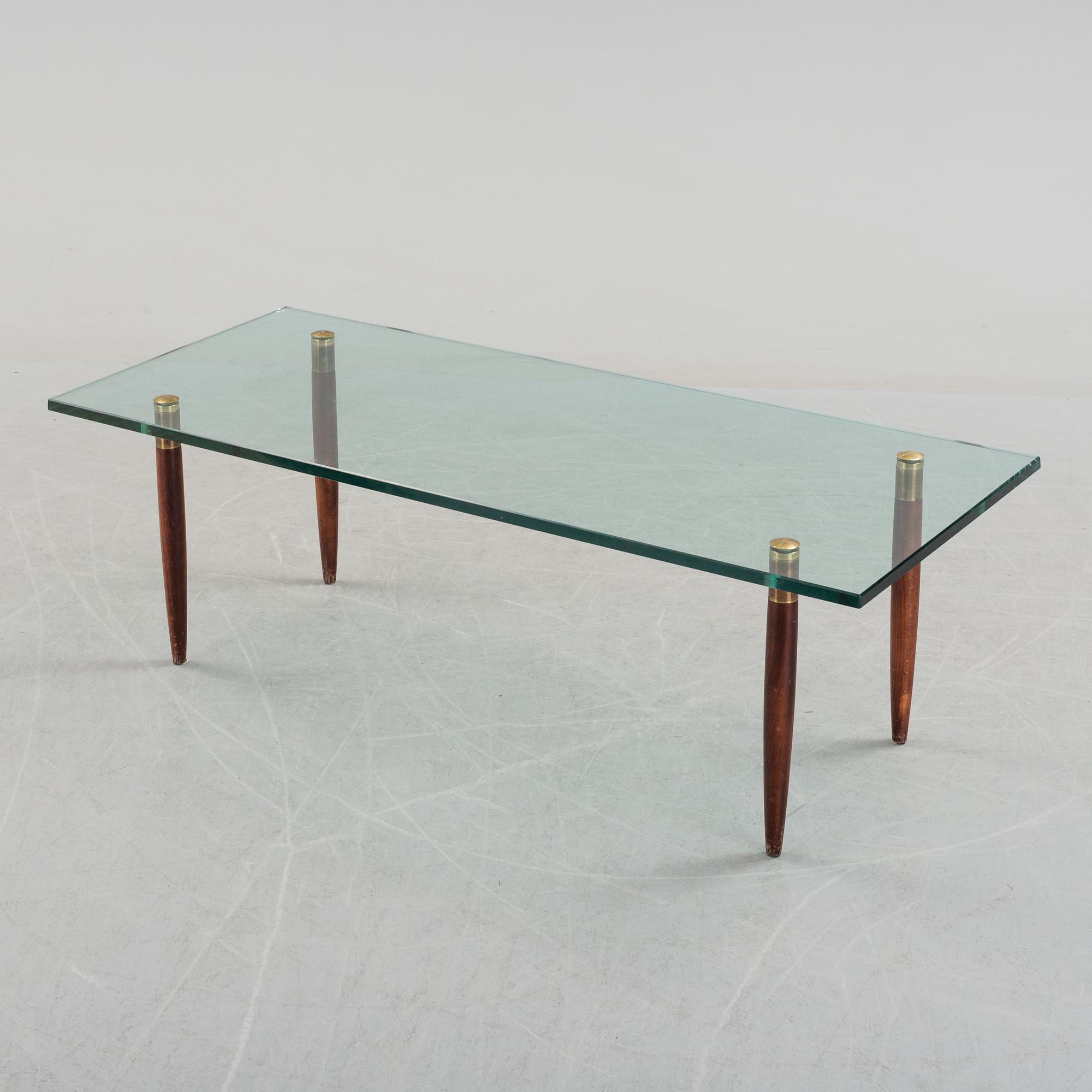 A 1960's glass sofa table.