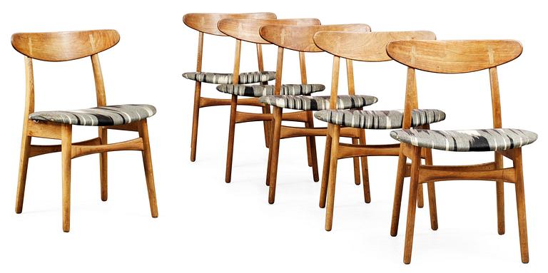 A set of six Hans J Wegner CH-30 oak and teak chairs by Carl Hansen, Denmark.