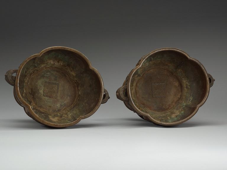 A pair of bronze flower pots, Qing dynasty, with Xuande six character mark to the interior.
