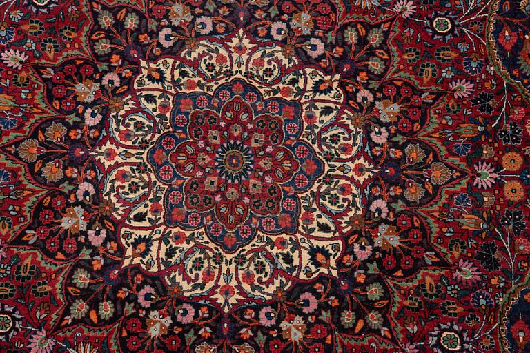 A carpet, semi-antique Mashad/Moud, ca 292 x 214 -218 cm.