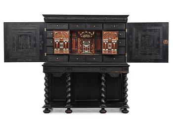 1. A Louis XIV and Louis XIV-style carved ebony, ivory and tortoiseshell-inlaid cabinet on stand, 17th and 19th century.